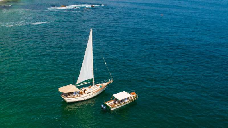 The classic sailboat Ada and the powerboat Bruna together on the blue waters of Banderas Bay.