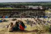 Migrants gathered near a border barrier